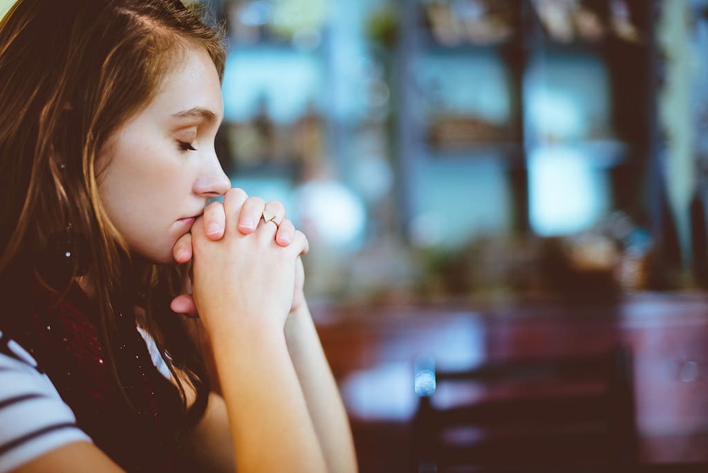 woman praying because her doctor's gone missing